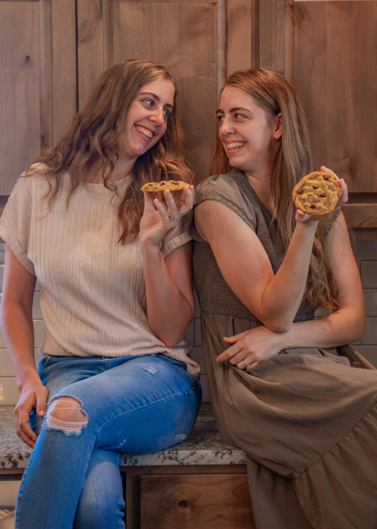 Two women sitting on kitchen counter