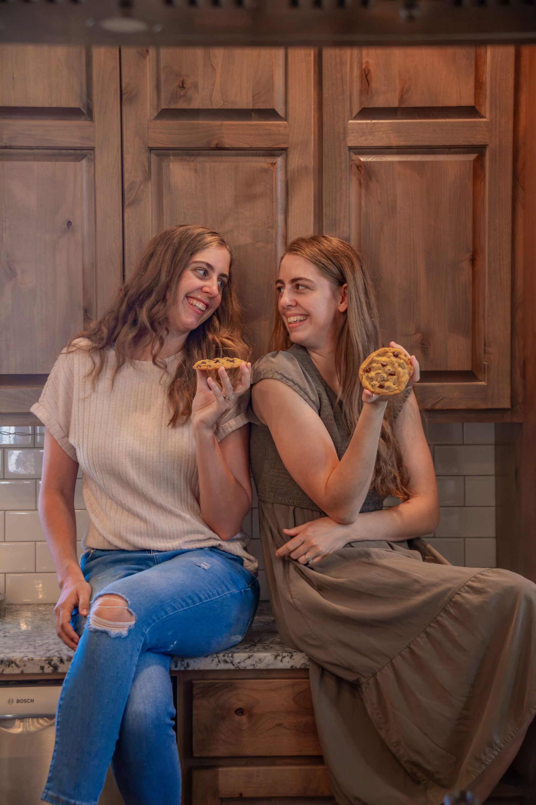 Two women sitting on kitchen counter