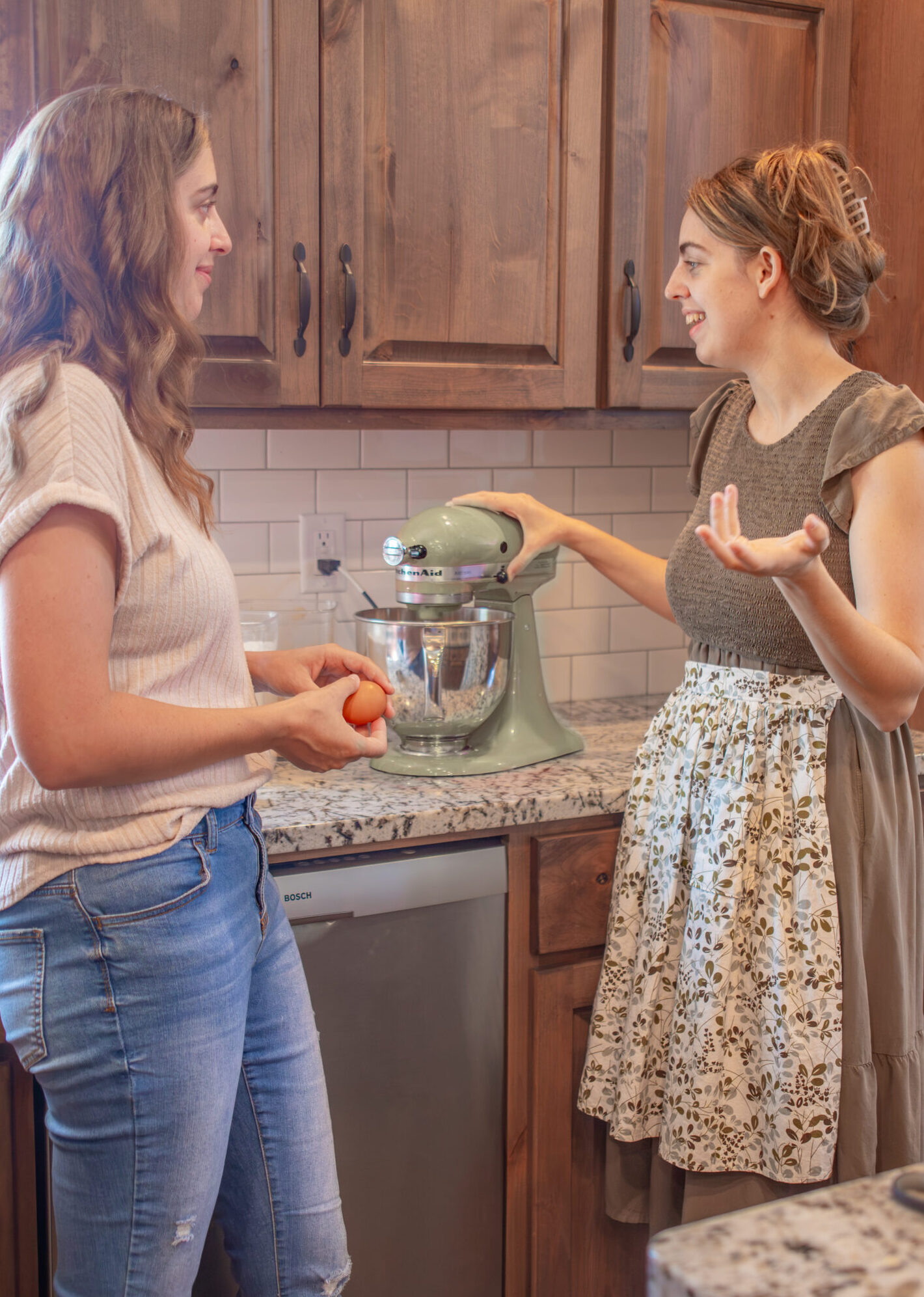 Two women cooking in a kitchen.